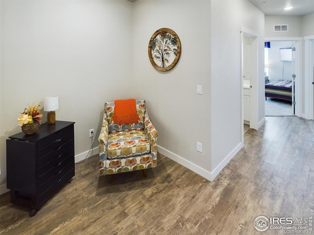 sitting room with dark hardwood / wood-style flooring