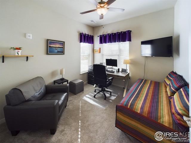 carpeted home office with ceiling fan