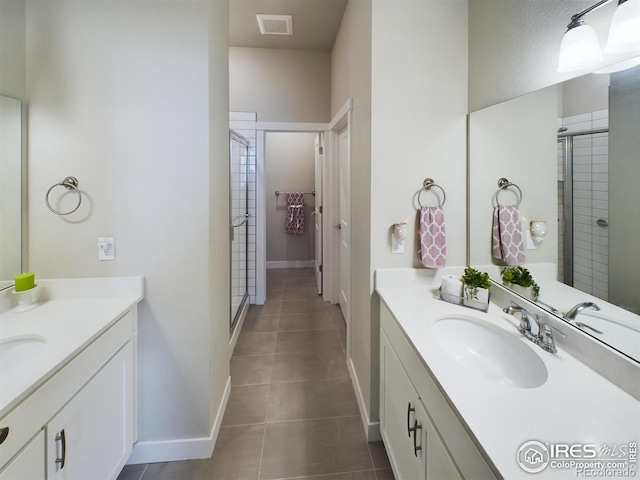 bathroom with vanity, a shower with shower door, and tile patterned floors