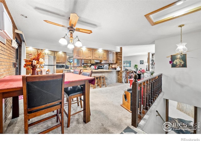 dining area with a textured ceiling, light colored carpet, and ceiling fan