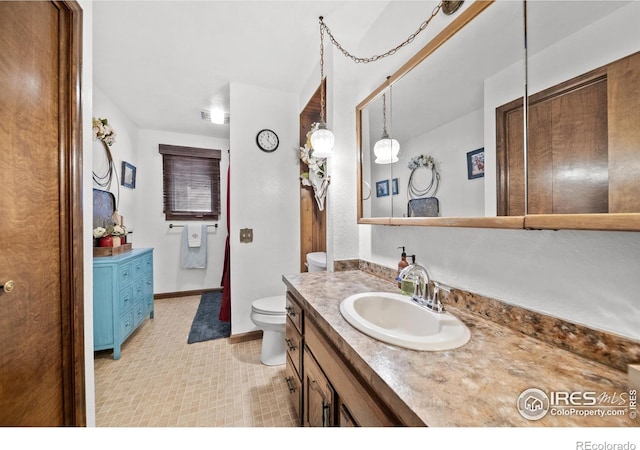 bathroom featuring toilet and vanity