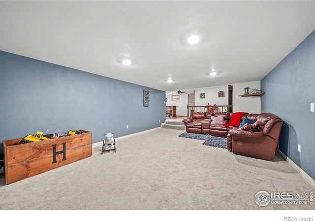 carpeted living room with ceiling fan