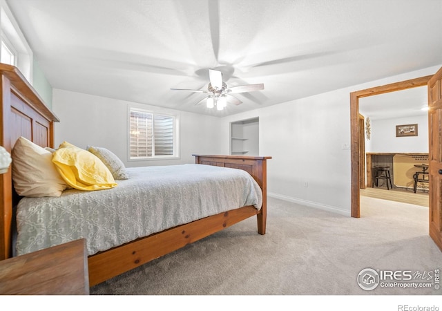 carpeted bedroom with multiple windows and ceiling fan