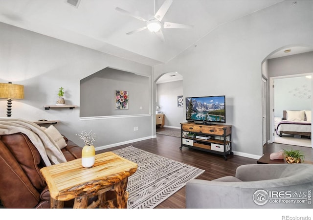 living room with lofted ceiling, dark wood-type flooring, and ceiling fan