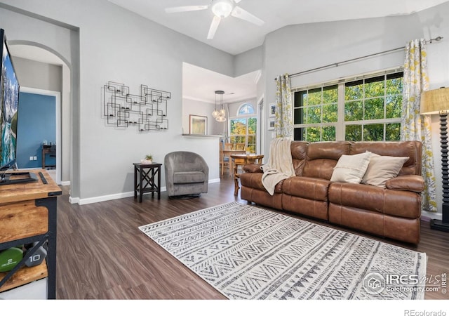 living room featuring lofted ceiling, dark hardwood / wood-style floors, and ceiling fan