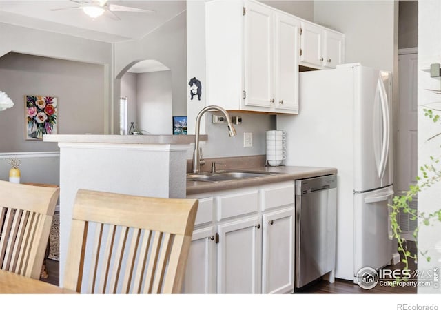 kitchen with dark wood-type flooring, sink, stainless steel dishwasher, white cabinetry, and ceiling fan