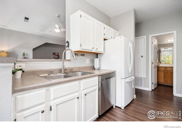 kitchen with appliances with stainless steel finishes, sink, white cabinetry, ceiling fan, and dark wood-type flooring