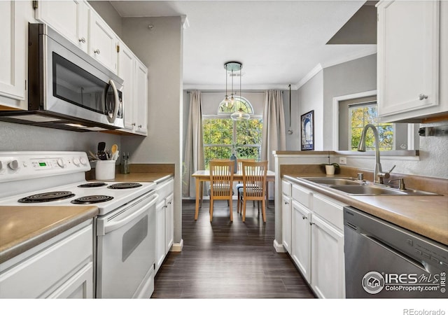 kitchen featuring sink, dark hardwood / wood-style flooring, stainless steel appliances, pendant lighting, and white cabinets