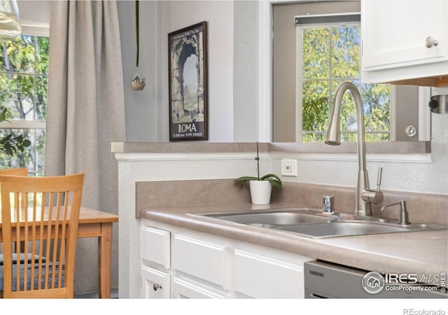 kitchen featuring white cabinets and sink