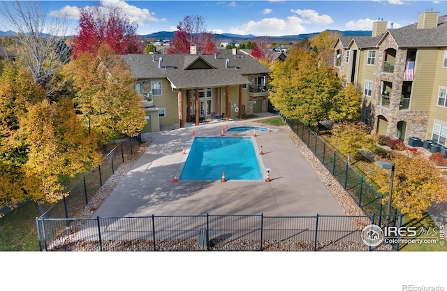 view of pool featuring a patio, cooling unit, and a mountain view