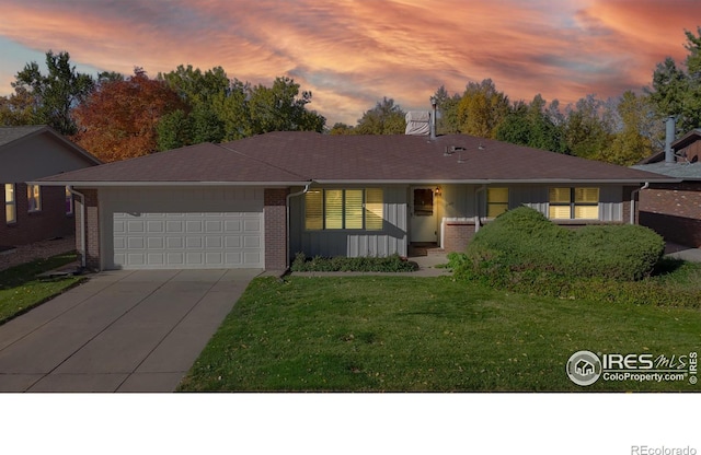 ranch-style home with a lawn, a porch, and a garage