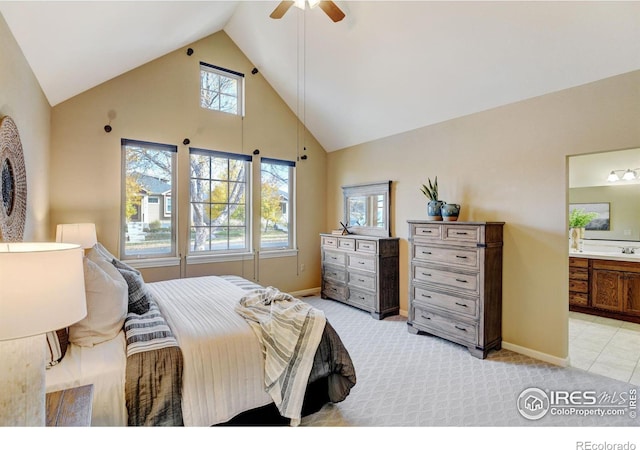 bedroom with light carpet, multiple windows, high vaulted ceiling, and ensuite bathroom