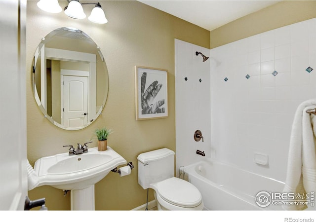 full bathroom featuring tiled shower / bath combo, sink, and toilet