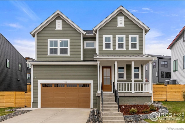 view of front of home featuring covered porch, a garage, and central air condition unit