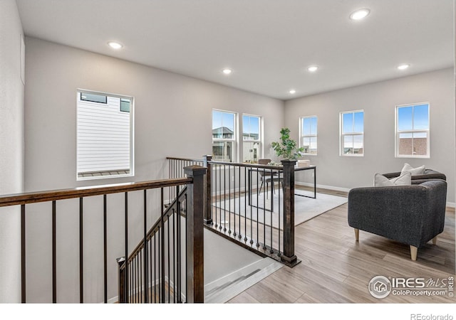 corridor with light hardwood / wood-style flooring