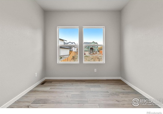 spare room featuring light wood-type flooring