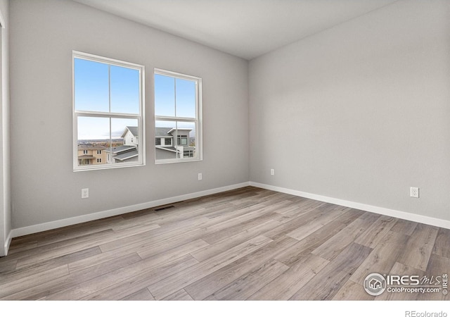 unfurnished room with light wood-type flooring