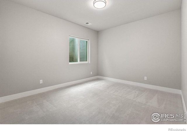 unfurnished room with light colored carpet