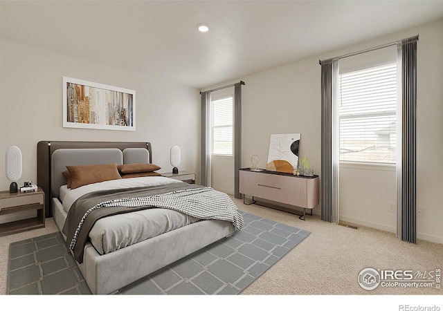 bedroom featuring light carpet, baseboards, and recessed lighting