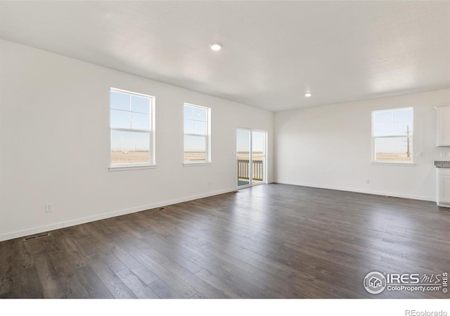 unfurnished room with dark hardwood / wood-style flooring