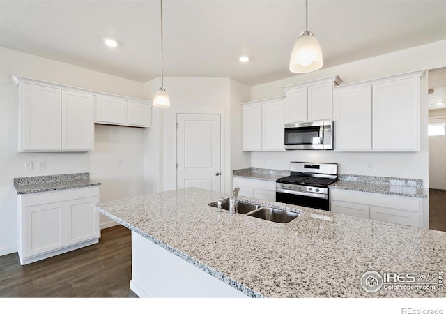 kitchen featuring appliances with stainless steel finishes, a sink, white cabinetry, dark wood-type flooring, and recessed lighting