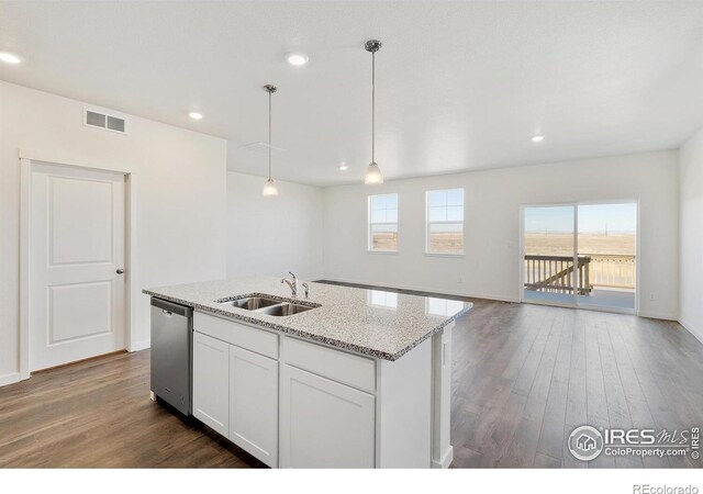 kitchen featuring a sink, stainless steel dishwasher, dark wood-style flooring, a kitchen island with sink, and white cabinets