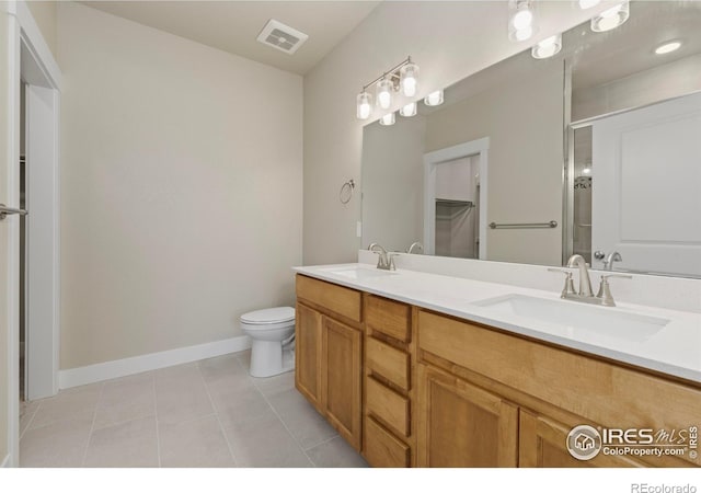 968 Birdwhistle Ln Unit 12, Fort Collins, CO 80524 - full bath featuring tile patterned flooring, double vanity, toilet, baseboards, and an enclosed shower