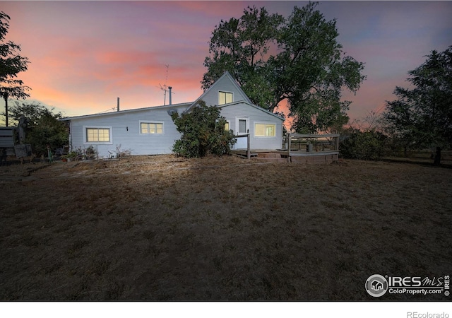 view of back house at dusk