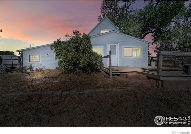 back house at dusk with a patio area