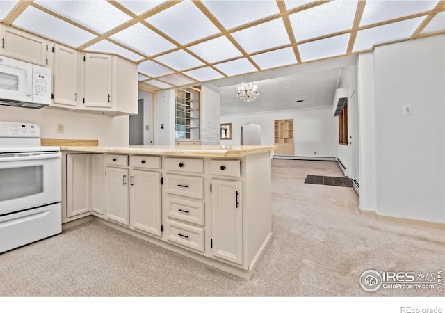 kitchen featuring white appliances, a baseboard heating unit, kitchen peninsula, light carpet, and a chandelier