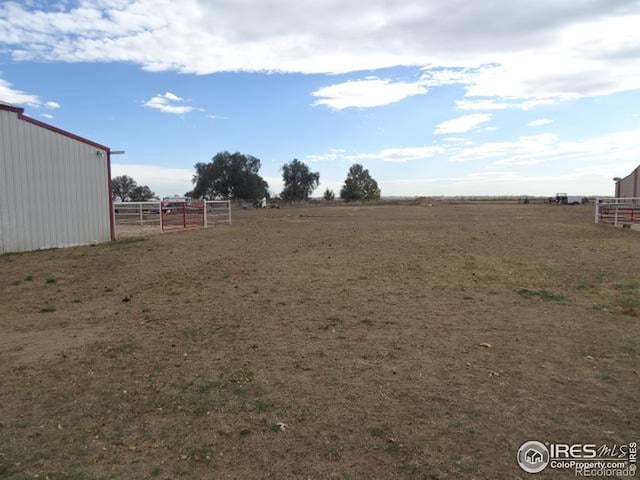 view of yard with a rural view