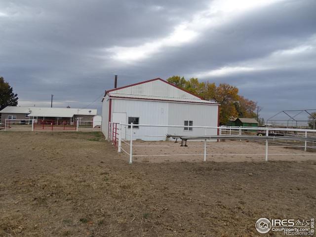 view of side of property with an outbuilding