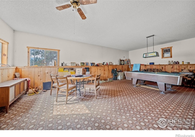 recreation room featuring ceiling fan, wood walls, a textured ceiling, and pool table