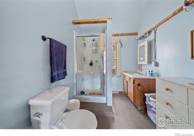 bathroom with vanity, toilet, a shower with door, and lofted ceiling