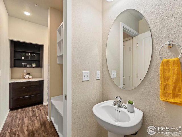 bathroom with hardwood / wood-style floors and sink