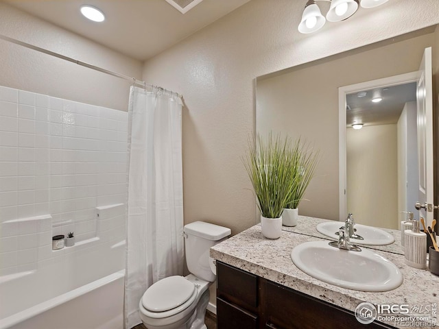 full bathroom featuring vanity, toilet, and shower / bathtub combination with curtain