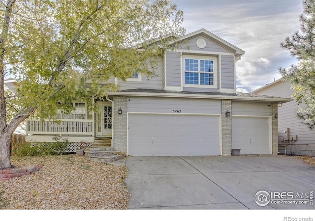 view of property with a garage and covered porch