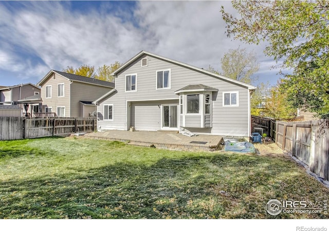 rear view of property featuring a patio area and a lawn