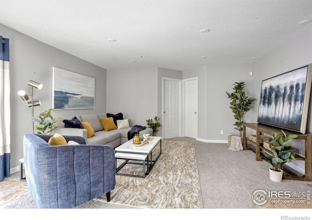 carpeted living room featuring a textured ceiling