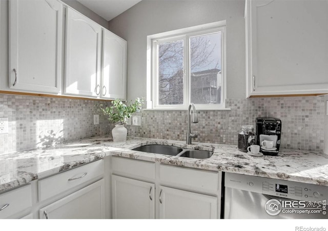 kitchen with sink, dishwasher, backsplash, light stone counters, and white cabinets