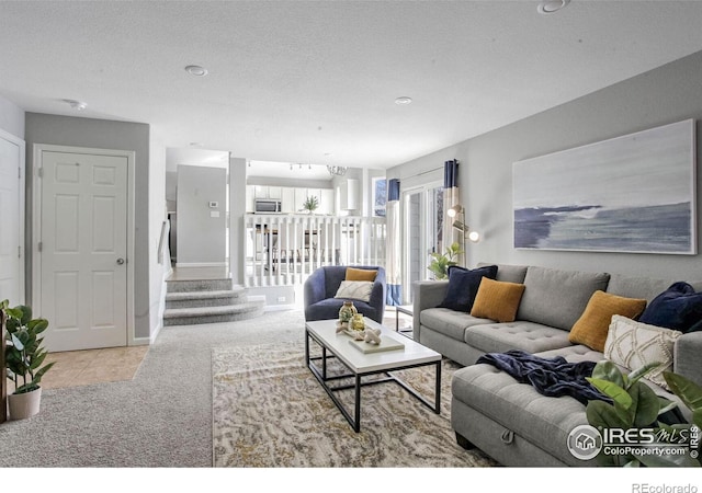 carpeted living room with a textured ceiling