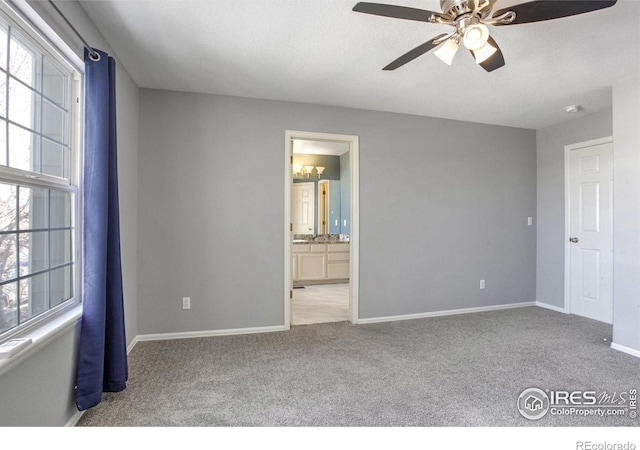 unfurnished bedroom with connected bathroom, light carpet, and ceiling fan