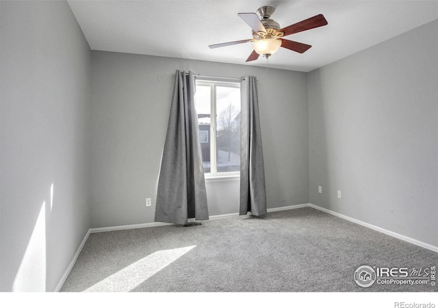 spare room featuring carpet and ceiling fan