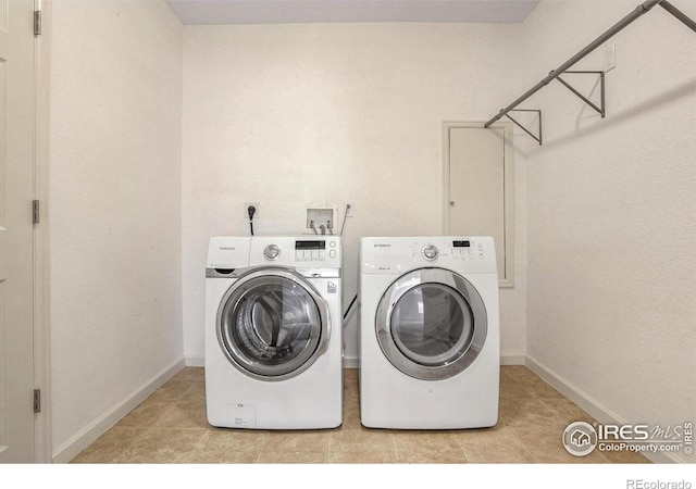 clothes washing area featuring independent washer and dryer and light tile patterned floors