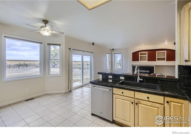 kitchen featuring sink, light brown cabinets, ceiling fan, light tile patterned floors, and stainless steel dishwasher