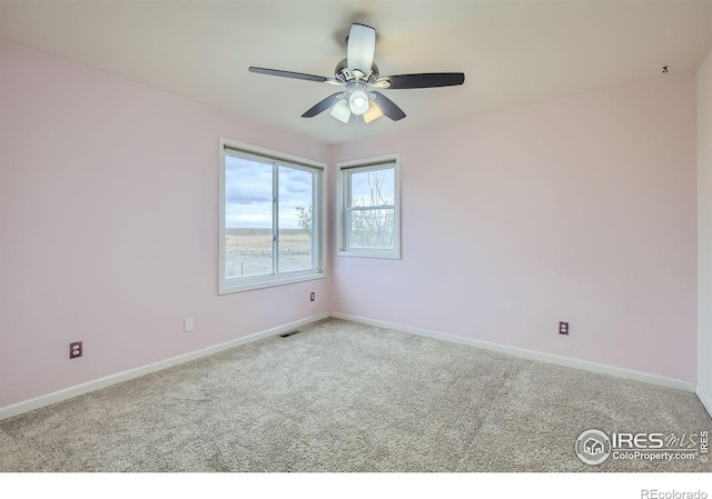 carpeted empty room with ceiling fan