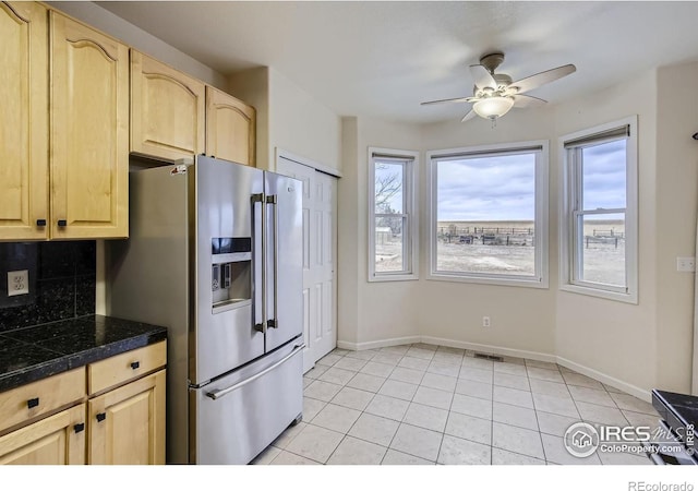 kitchen featuring light brown cabinetry, backsplash, stainless steel fridge with ice dispenser, and light tile patterned floors