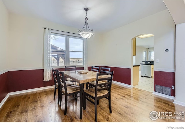 dining space with light wood-type flooring