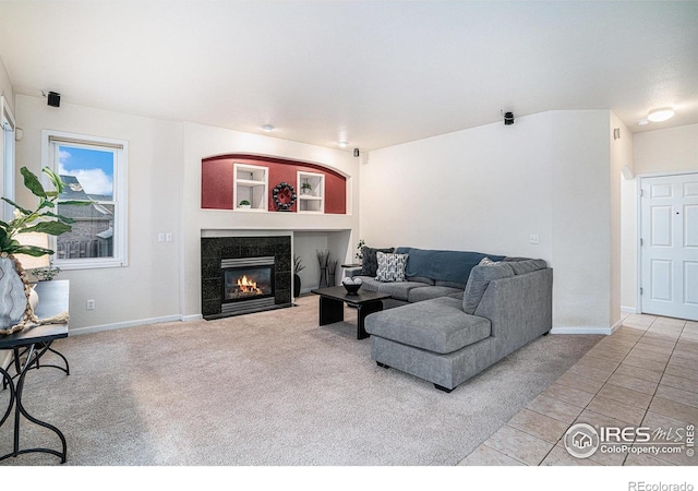 living room featuring a fireplace and carpet floors