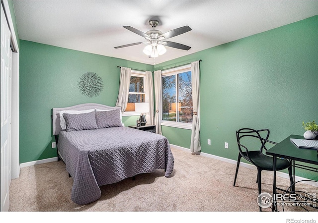 bedroom featuring light carpet, ceiling fan, and a closet